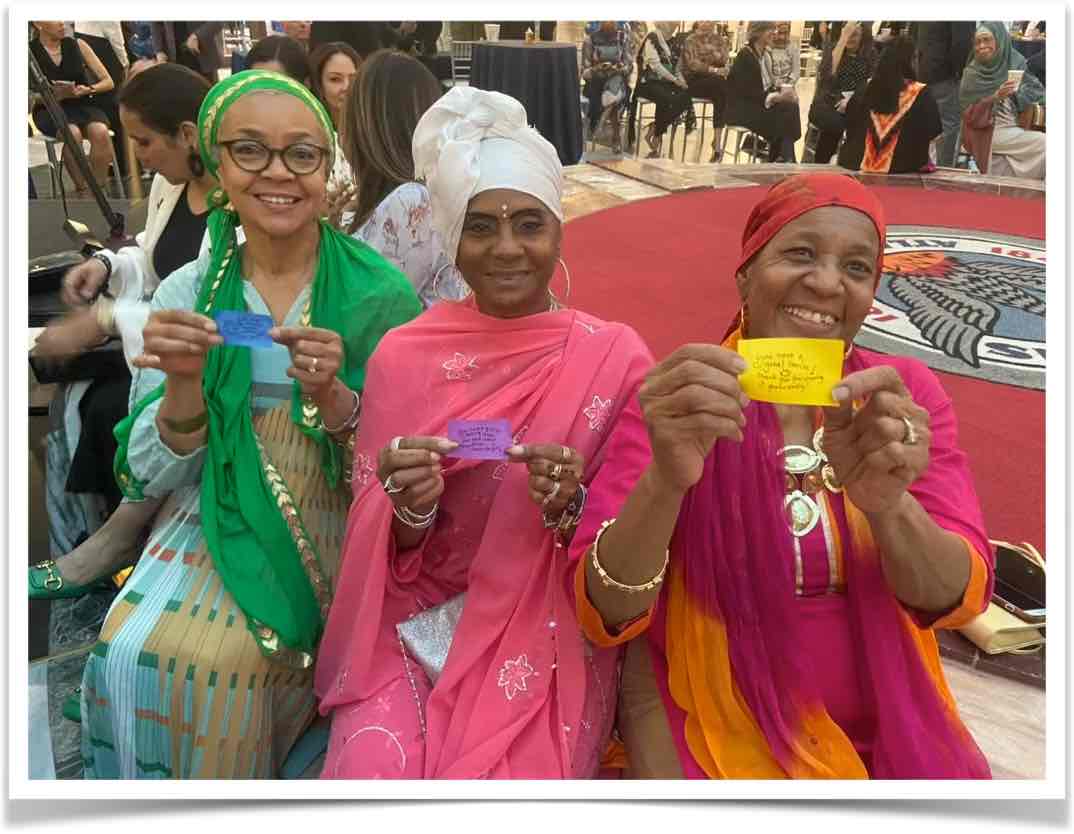 People holding love notes at Parliament of World Religions
